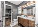 This bathroom features hardwood floors, gray walls, a toilet, and a wooden sink at 6599 Mcintosh Rd, Stanley, NC 28164