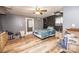 Bedroom with ceiling fan and access to exterior. Features wood-look flooring and gray walls at 6599 Mcintosh Rd, Stanley, NC 28164