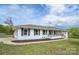 Charming, white, single-story home with dark shutters, wood porch, and well-maintained lawn at 6599 Mcintosh Rd, Stanley, NC 28164