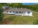 Charming single-story home with a welcoming porch, lush lawn, and white painted brick at 6599 Mcintosh Rd, Stanley, NC 28164