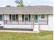 Inviting front porch with a light blue door and wood trim, adding curb appeal at 6599 Mcintosh Rd, Stanley, NC 28164