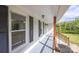 Spacious covered front porch with stylish lighting, and wooden railings at 6599 Mcintosh Rd, Stanley, NC 28164