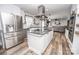 Bright kitchen features stainless steel appliances, island with cooktop and an open floorplan at 6599 Mcintosh Rd, Stanley, NC 28164