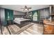 Dark primary bedroom with large bed, decorative wallpaper, and accent furniture at 6599 Mcintosh Rd, Stanley, NC 28164