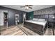 Dark primary bedroom with mirror, decor, accent furniture and modern decor at 6599 Mcintosh Rd, Stanley, NC 28164