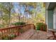 View from stained back deck, overlooking lush yard with mature trees at 6615 Wickville Dr, Charlotte, NC 28215