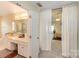 View from a bedroom to the bathroom with a large vanity and tub at 6615 Wickville Dr, Charlotte, NC 28215