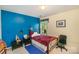 Bedroom with blue accent wall and natural light at 6615 Wickville Dr, Charlotte, NC 28215