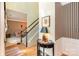 Inviting foyer with hardwood floors, a staircase with white railings, and decorative wall art and furnishings at 6615 Wickville Dr, Charlotte, NC 28215