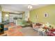 Open-concept living room with hardwood floors, comfortable sofas, and a view into the adjacent kitchen area at 6615 Wickville Dr, Charlotte, NC 28215