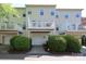 Townhome exterior with decks, garages, and green landscape, providing a private outdoor space at 729 Naramore St, Davidson, NC 28036