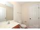Well-maintained bathroom with white fixtures, a vanity, and a neutral color scheme at 729 Naramore St, Davidson, NC 28036