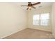 Carpeted bedroom with a ceiling fan and window at 729 Naramore St, Davidson, NC 28036