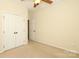 Bedroom featuring neutral carpet, fan, and closet at 729 Naramore St, Davidson, NC 28036