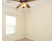 A bright bedroom with tan carpet and a large window at 729 Naramore St, Davidson, NC 28036