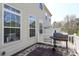 View of deck featuring white railing and grill, with a backdrop of neighboring home at 729 Naramore St, Davidson, NC 28036