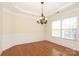 Charming dining room with elegant chandelier, wainscoting, and large windows for abundant natural light at 729 Naramore St, Davidson, NC 28036