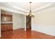 Open-concept dining area with hardwood floors, decorative molding, and easy access to kitchen at 729 Naramore St, Davidson, NC 28036