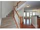 Open entryway featuring hardwood floors and a staircase with wood and white banisters at 729 Naramore St, Davidson, NC 28036