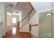 Inviting entryway with hardwood floors and staircase with white spindles and natural wood handrail at 729 Naramore St, Davidson, NC 28036