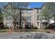 Brick townhome featuring traditional architecture, manicured landscaping, and inviting entryway at 729 Naramore St, Davidson, NC 28036