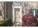 Elegant entryway with classic door, brick facade, manicured shrubs, and decorative light fixture at 729 Naramore St, Davidson, NC 28036