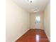 Hallway with hardwood floors leading to an exterior door at 729 Naramore St, Davidson, NC 28036