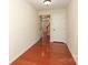 Hallway with hardwood floors leading to an adjacent room and a closet at 729 Naramore St, Davidson, NC 28036