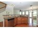 Cozy kitchen area with wood cabinets, granite countertops, and stainless steel dishwasher at 729 Naramore St, Davidson, NC 28036