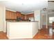 Well-lit kitchen with wood cabinetry, granite countertops, and stainless steel appliances for a modern touch at 729 Naramore St, Davidson, NC 28036