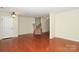 Spacious living room featuring beautiful hardwood floors and ample natural light from backyard access at 729 Naramore St, Davidson, NC 28036