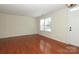 Comfortable living area featuring hardwood floors, neutral walls, and bright windows for natural light at 729 Naramore St, Davidson, NC 28036