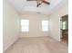 A bright main bedroom features neutral carpet and a tray ceiling with fan at 729 Naramore St, Davidson, NC 28036