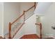 Staircase showcasing wood railing, carpeted steps, and neutral walls, offering a seamless transition between floors at 729 Naramore St, Davidson, NC 28036