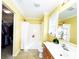 Bright bathroom featuring a tub shower with a white shower curtain and a single sink vanity at 7928 Ponderosa Pine Ln, Charlotte, NC 28215