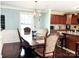 Dining area features an elegant table and chairs, adjacent to a modern kitchen at 7928 Ponderosa Pine Ln, Charlotte, NC 28215