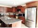 Well-equipped kitchen with granite counters, stainless steel appliances, and an island with seating at 7928 Ponderosa Pine Ln, Charlotte, NC 28215