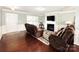 Inviting living room featuring hardwood floors, a fireplace, and comfortable seating at 7928 Ponderosa Pine Ln, Charlotte, NC 28215