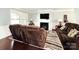 Inviting living room with plush seating, a fireplace, and a mounted TV at 7928 Ponderosa Pine Ln, Charlotte, NC 28215