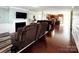 Open-concept living area with hardwood floors, a fireplace, and easy access to the kitchen at 7928 Ponderosa Pine Ln, Charlotte, NC 28215