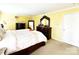 Spacious main bedroom with carpet, yellow walls, large bed and wooden dresser at 7928 Ponderosa Pine Ln, Charlotte, NC 28215