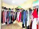 Spacious walk-in closet offers organized storage with hanging racks and shelving for clothes and accessories at 7928 Ponderosa Pine Ln, Charlotte, NC 28215