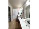 Bright bathroom with double vanity, decorative mirror accents, and tile flooring at 811 Wynnshire Dr # A, Hickory, NC 28601