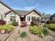 Charming home featuring stone and siding exterior, arched windows, and colorful landscaping at 811 Wynnshire Dr # A, Hickory, NC 28601