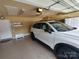 Attached garage with epoxy floors and a modern white SUV parked inside at 811 Wynnshire Dr # A, Hickory, NC 28601