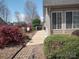 A home walkway is flanked by manicured landscaping including colorful bushes and mature trees at 811 Wynnshire Dr # A, Hickory, NC 28601