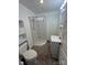 Compact bathroom including a shower stall, toilet, and a vanity sink at 818 N 4Th St, Albemarle, NC 28001