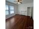 Bright bedroom featuring hardwood floors, a ceiling fan, a fireplace and a closet at 818 N 4Th St, Albemarle, NC 28001