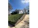 A charming home is perched atop a retaining wall with a beautiful, grassy landscape at 818 N 4Th St, Albemarle, NC 28001