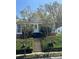 Charming home featuring a welcoming front yard with lush greenery and inviting entrance stairs at 818 N 4Th St, Albemarle, NC 28001
